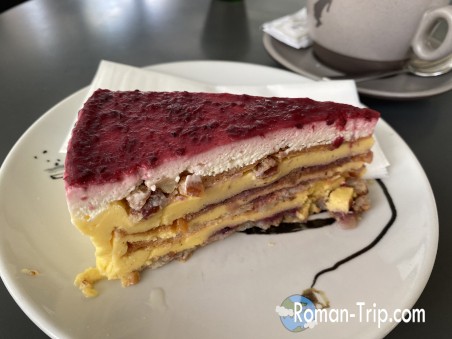 A delectable berry mousse cake from Amelie, a charming patisserie in Zagreb. This dessert features a light and creamy texture with a burst of fresh berry flavors, beautifully crafted for a perfect sweet indulgence.