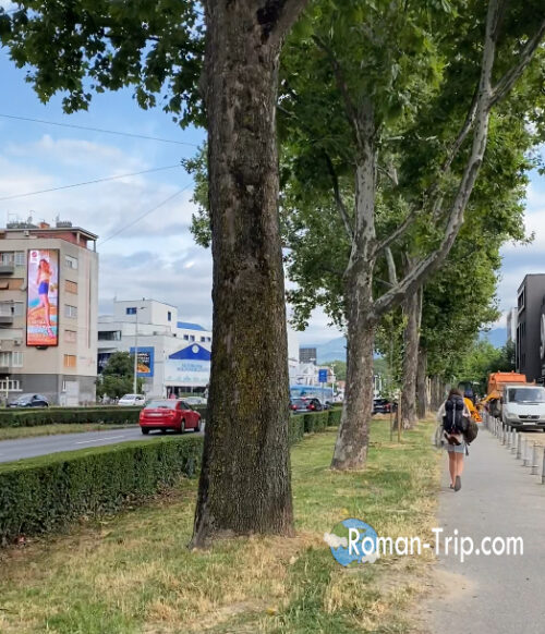 A busy street in Zagreb during the morning, with cars passing by.