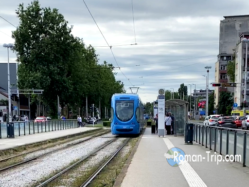 Morning scene at a tram station in Zagreb, with passengers waiting.