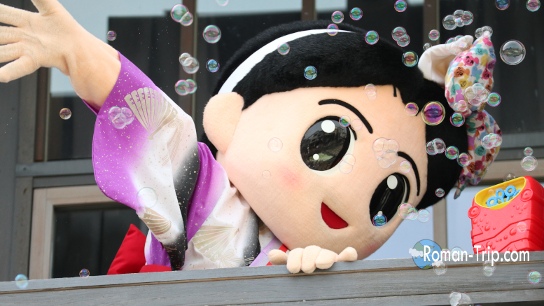 草津温泉の名物キャラクター「ゆもみちゃん」。伝統の湯もみをモチーフにした、温泉街で親しまれるご当地マスコット。/ “Yumomi-chan,” the iconic mascot of Kusatsu Onsen — a beloved local character inspired by the traditional hot water stirring culture of the onsen town.
