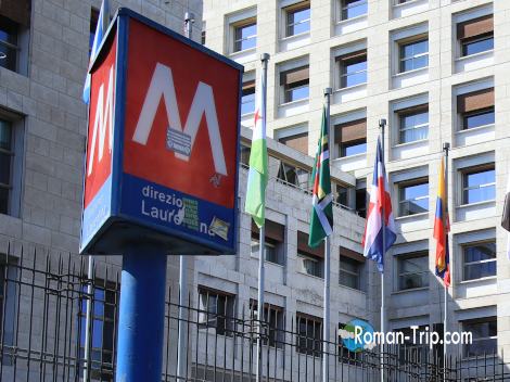 イタリアの地下鉄入口を示す「M」のマーク。赤い背景に白い文字が目印で、街中でよく見かける。/ The "M" sign indicating the entrance to the Italian metro — a common sight in cities, marked by white lettering on a red background.