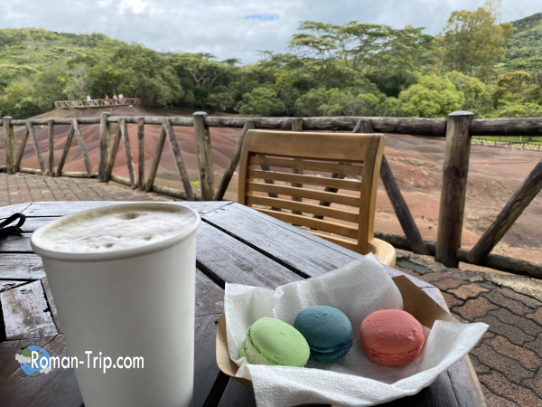 モーリシャスの七色の大地を眺めながら、カフェのテラス席で七色のマカロンをいただいたひととき。観光地の景色と甘い時間。/ Enjoying rainbow macarons at a terrace cafe while overlooking the Seven Colored Earth in Mauritius
